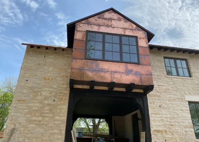 Copper metal panel facade on a stone building for Metal Roof Coating in Spokane