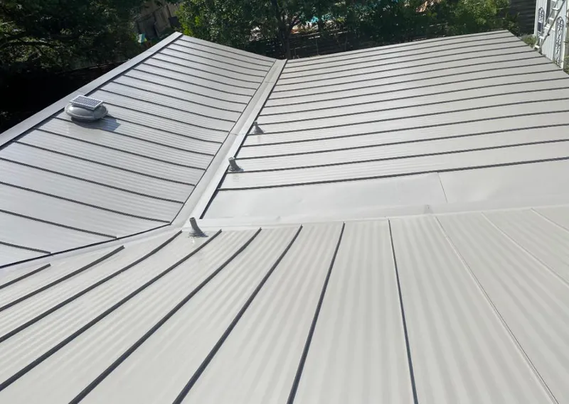 Solar attic fan installed on a metal roof for Roof Ventilation in Spokane