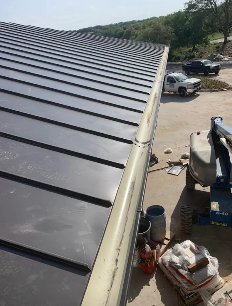 Standing seam panel and gutter detail on a metal roofing jobsite in Spokane